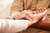 two people's hands caring for health and wellness image