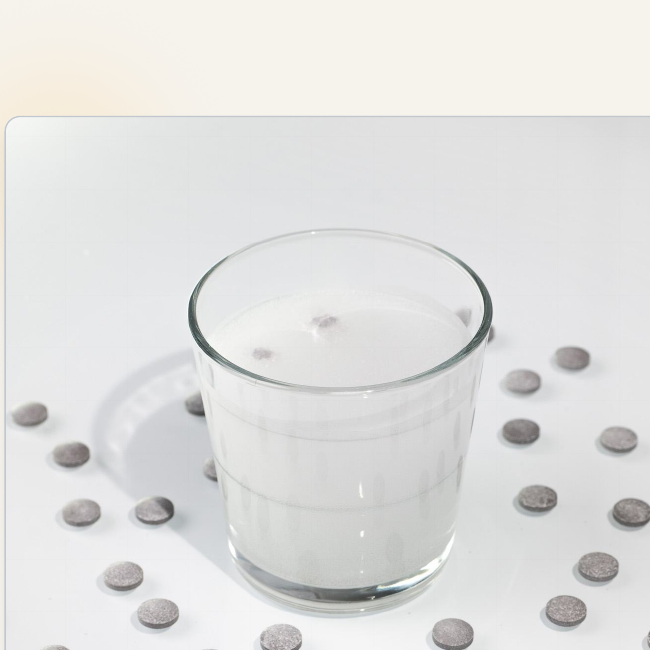 Molecular hydrogen tablets near a glass of water